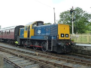 A Class 14 with a rake of carriage sitting at a train station