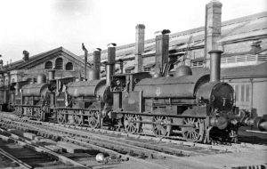 View northward, outside the extensive ex-London & North Western Carriage Works, which bordered the West Coast Main Line just west of Wolverton Station. The locomotives were ex-LNW 'Special' 2F 0-6-0 saddle-tanks, Carriage Dept. Nos. 3, 6 and 7. (The fourth member of the team, No. 8 'Earlestown', is just out of frame on the right.