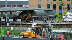 Aftermath of The Potter's Bar Derailment with the remains on the train on it's side stuck under the station roof
