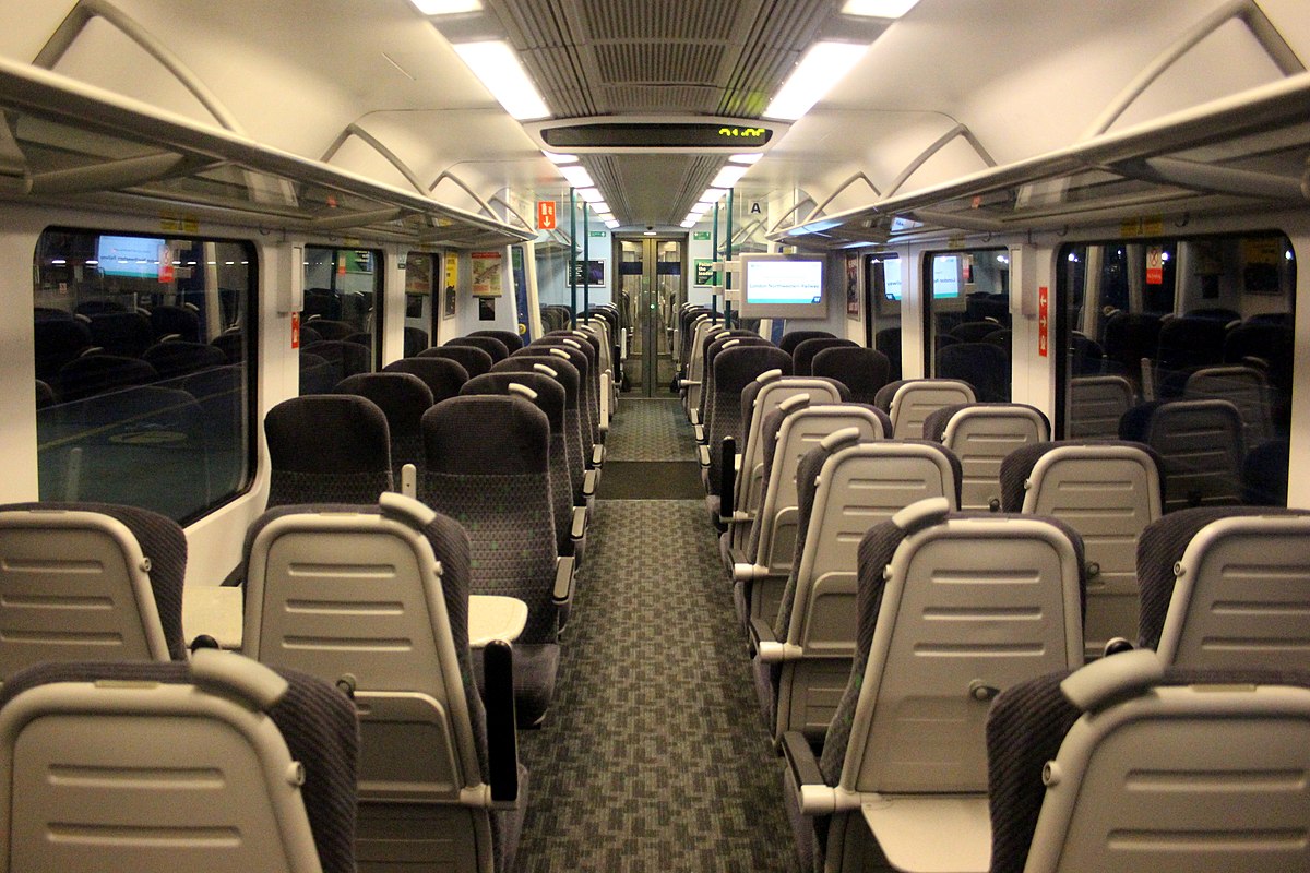 The interior of a class 350 now in service since 2005 looking outdated with dimed lighting and dark coloured seats