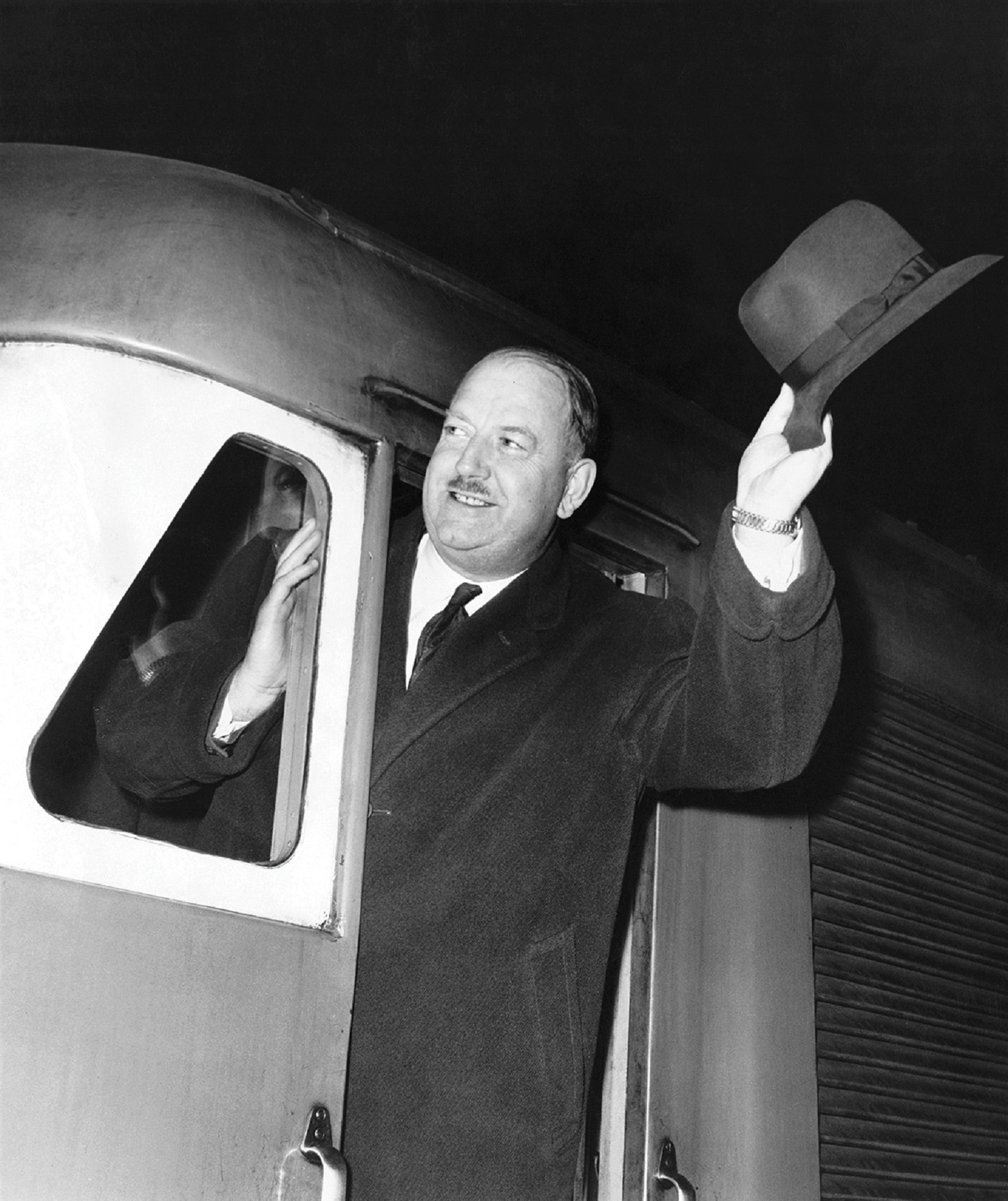 Beeching waving from a train